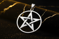 Silver pentagram pendant with black and gold background